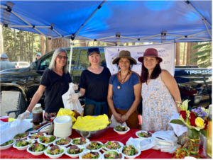 Laura Fillmore, Galena Angarova, Lisa Grayshield and Laura Luna serving salads at the Elder's Dinner